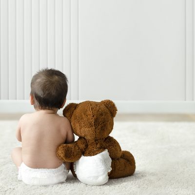 Baby and teddy bear rear view with design space