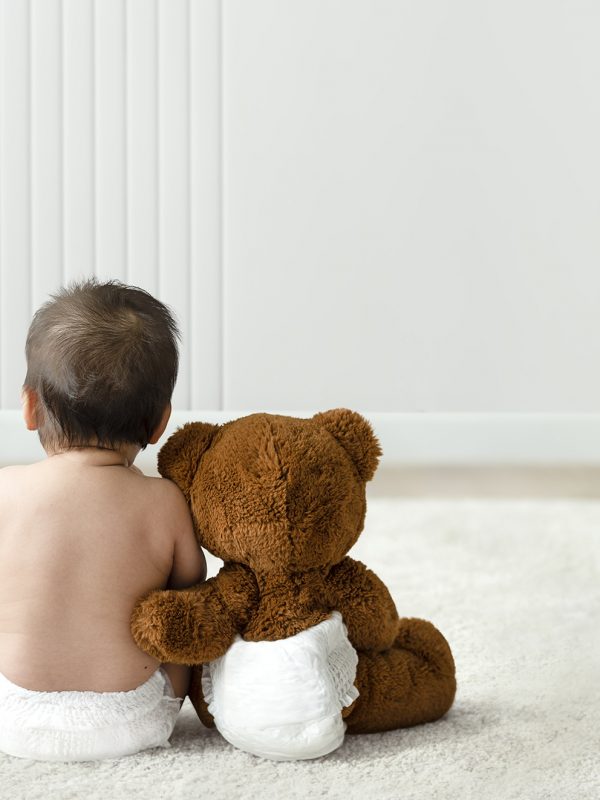 Baby and teddy bear rear view with design space