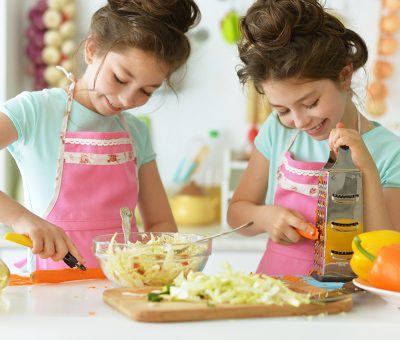 Two girls sisters in the kitchen cook