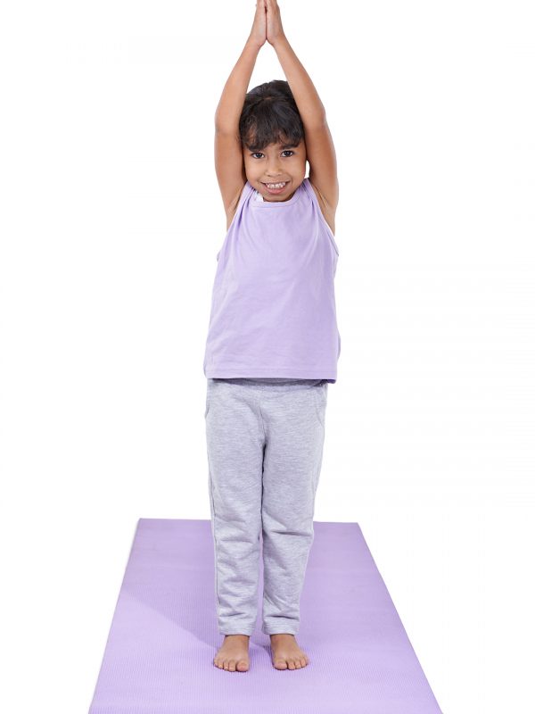 a cute little girl doing yoga.